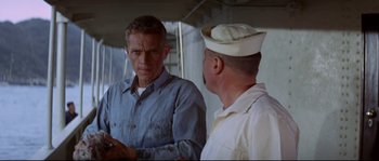 Movie still from “The Sand Pebbles” (1966), directed by Robert Wise – Two men are standing next to each other; Medium shot, Over the shoulder angle