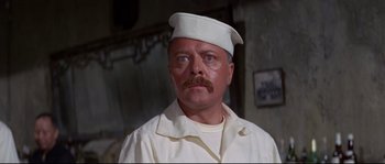 Movie still from “The Sand Pebbles” (1966), directed by Robert Wise – A man with a mustache wearing a sailor's hat; Close Up shot, Low angle