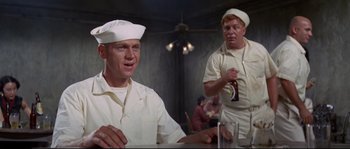 Movie still from “The Sand Pebbles” (1966), directed by Robert Wise – A couple of men sitting at a table in front of a mirror; Medium shot, Low angle