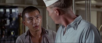 Movie still from “The Sand Pebbles” (1966), directed by Robert Wise – Two men are looking at each other in a room; Close Up shot, Over the shoulder angle