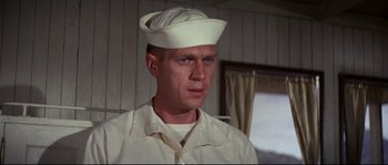 Movie still from “The Sand Pebbles” (1966), directed by Robert Wise – A man wearing a sailor's hat in a room with a window; Close Up shot, Low angle