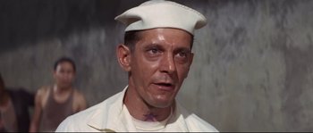 Movie still from “The Sand Pebbles” (1966), directed by Robert Wise – A person wearing a hat; Close Up shot, High angle
