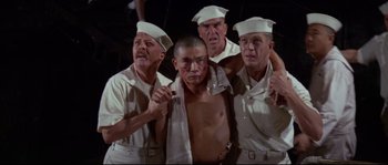 Movie still from “The Sand Pebbles” (1966), directed by Robert Wise – A group of men standing next to each other; Medium shot, Low angle