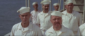 Movie still from “The Sand Pebbles” (1966), directed by Robert Wise – A group of men in white shirts and white hats; Medium shot, Low angle