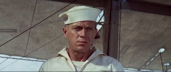Movie still from “The Sand Pebbles” (1966), directed by Robert Wise – A man wearing a sailor's hat and a white shirt; Close Up shot, Low angle