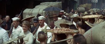 Movie still from “The Sand Pebbles” (1966), directed by Robert Wise – A group of men standing next to each other holding umbrellas; Medium shot, High angle