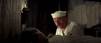 Movie still from “The Sand Pebbles” (1966), directed by Robert Wise – A man wearing a sailor's hat looking down at a woman; Close Up shot, Over the shoulder angle
