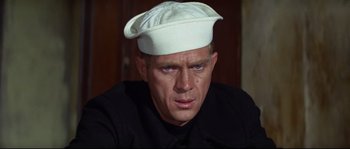Movie still from “The Sand Pebbles” (1966), directed by Robert Wise – A person wearing a hat; Close Up shot, Over the shoulder angle