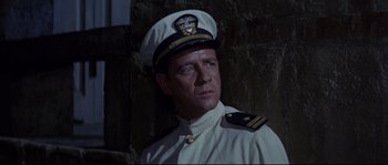 Movie still from “The Sand Pebbles” (1966), directed by Robert Wise – A person wearing a uniform and wearing a hat; Medium shot, Low angle