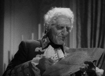Movie still from “The Scarlet Empress” (1934), directed by Josef von Sternberg – An old man is holding a piece of paper; Close Up shot, Over the shoulder angle