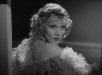 Movie still from “The Scarlet Empress” (1934), directed by Josef von Sternberg – An old black and white photo of a woman in a ruffled dress; Close Up shot, High angle
