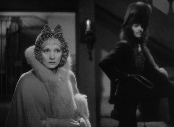 Movie still from “The Scarlet Empress” (1934), directed by Josef von Sternberg – A woman in a fur coat standing next to another woman in a fur coat; Medium shot, Over the shoulder angle