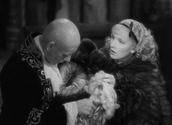 Movie still from “The Scarlet Empress” (1934), directed by Josef von Sternberg – An old photo of a man and a woman; Medium shot, Over the shoulder angle