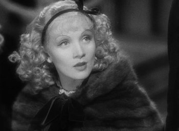 Movie still from “The Scarlet Empress” (1934), directed by Josef von Sternberg – An old photo of a woman in a fur coat; Close Up shot, Over the shoulder angle