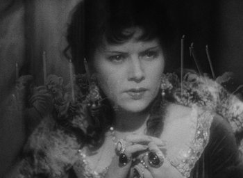 Movie still from “The Scarlet Empress” (1934), directed by Josef von Sternberg – A black - and - white photo of a woman in front of a mirror; Close Up shot, High angle