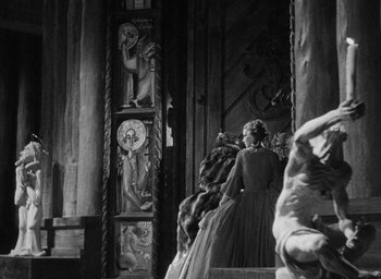 Movie still from “The Scarlet Empress” (1934), directed by Josef von Sternberg – A black and white photo of a woman in a dress; Wide shot, Over the shoulder angle