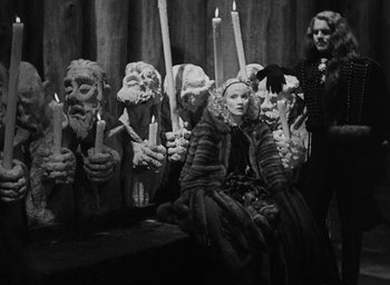 Movie still from “The Scarlet Empress” (1934), directed by Josef von Sternberg – A group of people holding candles in their hands; Wide shot, High angle