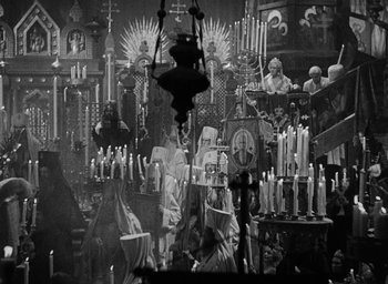 Movie still from “The Scarlet Empress” (1934), directed by Josef von Sternberg – A black and white photo of a church with many candles; Wide shot, High angle