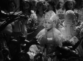 Movie still from “The Scarlet Empress” (1934), directed by Josef von Sternberg – A group of people in costumes in a room; Medium shot, High angle