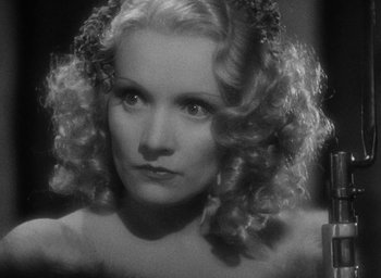 Movie still from “The Scarlet Empress” (1934), directed by Josef von Sternberg – A black and white photo of a woman with curly hair; Close Up shot, Low angle