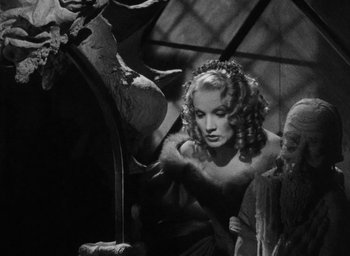 Movie still from “The Scarlet Empress” (1934), directed by Josef von Sternberg – A black - and - white photo of a woman in a dress; Medium shot, Low angle