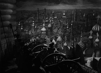 Movie still from “The Scarlet Empress” (1934), directed by Josef von Sternberg – A black and white painting of a city with many buildings; Wide shot, High angle