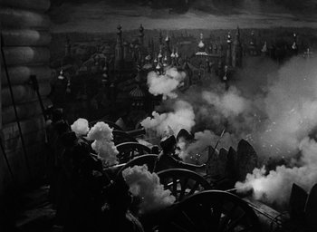 Movie still from “The Scarlet Empress” (1934), directed by Josef von Sternberg – A black - and - white photo of a city with smoke coming out of it; Extreme Wide shot, High angle