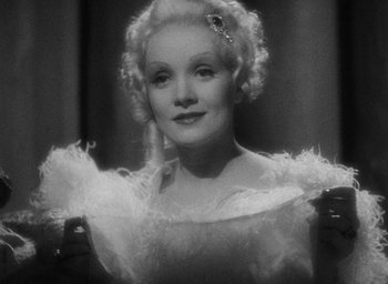 Movie still from “The Scarlet Empress” (1934), directed by Josef von Sternberg – An old black and white photo of a woman in a white dress; Close Up shot, Low angle