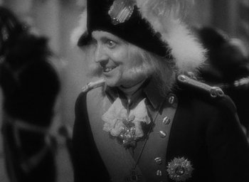 Movie still from “The Scarlet Empress” (1934), directed by Josef von Sternberg – A man dressed in a uniform and a hat; Close Up shot, Over the shoulder angle