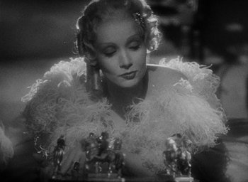 Movie still from “The Scarlet Empress” (1934), directed by Josef von Sternberg – A black - and - white photo of a woman in a white dress; Close Up shot, Over the shoulder angle