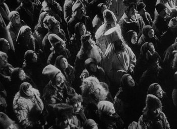 Movie still from “The Scarlet Empress” (1934), directed by Josef von Sternberg – A group of people sitting on top of each other; Wide shot, High angle