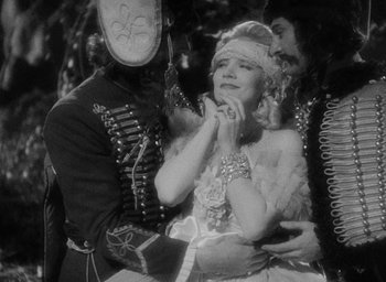 Movie still from “The Scarlet Empress” (1934), directed by Josef von Sternberg – An old photo of a man and a woman; Medium shot, High angle