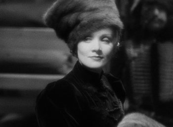 Movie still from “The Scarlet Empress” (1934), directed by Josef von Sternberg – An old photo of a woman wearing a fur hat; Close Up shot, High angle