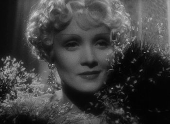 Movie still from “The Scarlet Empress” (1934), directed by Josef von Sternberg – An old photo of a woman with a flower in her hair; Close Up shot, Low angle