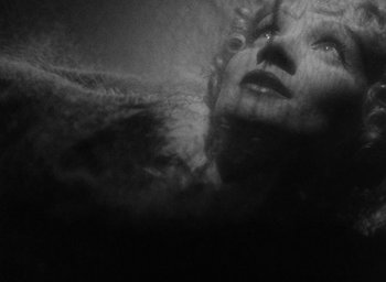Movie still from “The Scarlet Empress” (1934), directed by Josef von Sternberg – A black - and - white photo of a woman's face; Extreme Close Up shot, Overhead angle