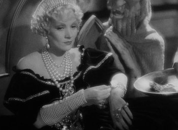 Movie still from “The Scarlet Empress” (1934), directed by Josef von Sternberg – An old photo of an old woman wearing pearls; Close Up shot, High angle