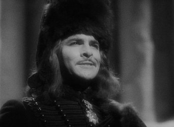 Movie still from “The Scarlet Empress” (1934), directed by Josef von Sternberg – A man with long hair wearing a fur hat; Close Up shot, Over the shoulder angle