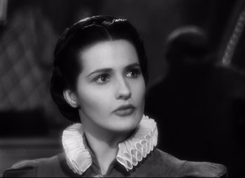 Movie still from “The Sea Hawk” (1940), directed by Michael Curtiz – A black - and - white photo of a woman in a dress; Close Up shot, Low angle