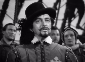 Movie still from “The Sea Hawk” (1940), directed by Michael Curtiz – A black and white photo of a man in a top hat; Close Up shot, Low angle