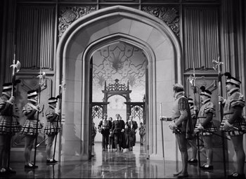 Movie still from “The Sea Hawk” (1940), directed by Michael Curtiz – A group of people standing in front of an archway; Extreme Wide shot, High angle