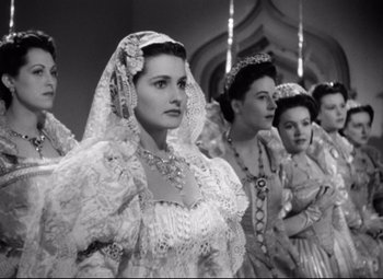 Movie still from “The Sea Hawk” (1940), directed by Michael Curtiz – A black and white photo of a group of women in medieval garb; Medium shot, Low angle