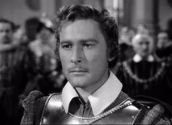 Movie still from “The Sea Hawk” (1940), directed by Michael Curtiz – Black and white photograph of a man wearing a suit of armor; Close Up shot, High angle