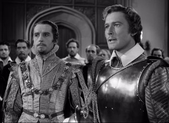 Movie still from “The Sea Hawk” (1940), directed by Michael Curtiz – A black and white photo of two men in medieval garb; Medium shot, Over the shoulder angle