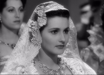Movie still from “The Sea Hawk” (1940), directed by Michael Curtiz – A black and white photo of a woman wearing a veil; Close Up shot, Over the shoulder angle