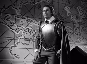 Movie still from “The Sea Hawk” (1940), directed by Michael Curtiz – A black and white photo of a man in a suit of armor; Medium shot, High angle