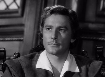 Movie still from “The Sea Hawk” (1940), directed by Michael Curtiz – Black and white photograph of a man with long hair; Close Up shot, Low angle