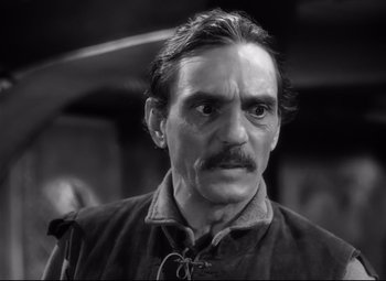 Movie still from “The Sea Hawk” (1940), directed by Michael Curtiz – An older man with a mustache and a mustache comb; Close Up shot, High angle