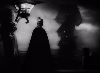Movie still from “The Sea Hawk” (1940), directed by Michael Curtiz – A black and white photo of a pirate ship; Wide shot, Low angle