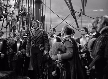 Movie still from “The Sea Hawk” (1940), directed by Michael Curtiz – A black and white photo of people on a boat; Wide shot, Low angle