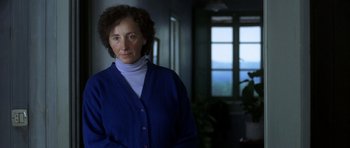 Movie still from “The Sea Inside” (2004), directed by Alejandro Amenábar – A woman standing in a room with a window in the background; Close Up shot, Over the shoulder angle